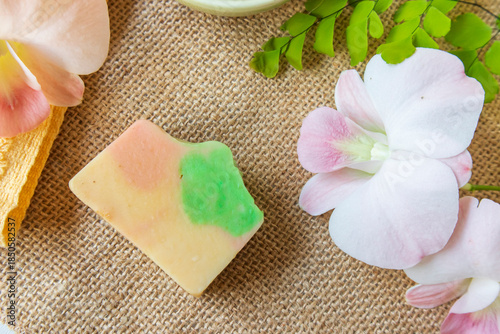 Handmade soap on burlap with orchid flower, towel and bath salt, Concept of sustainable use, bath products. Flat lay
