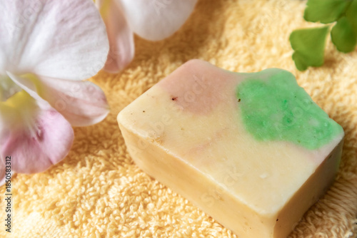 Handmade soap on burlap with orchid flower, towel and bath salt, Concept of sustainable use, bath products. Flat lay
