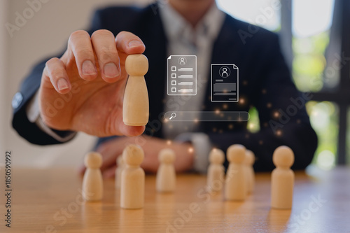 Fotografie Business leader selecting candidate with wooden figures, recruitment hiring and human resources selection concept, talent selection and human resources management