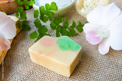 Handmade soap on burlap with orchid flower, towel and bath salt, Concept of sustainable use, bath products. Flat lay