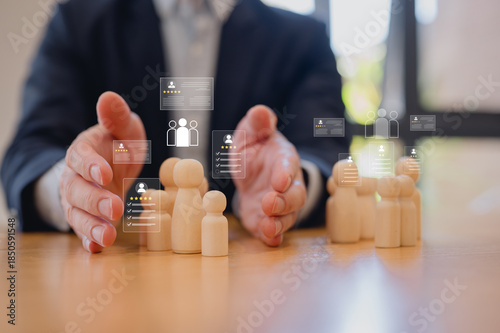 Принти на полотні Businessman protecting wooden people figures with digital customer profile icons