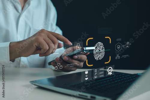 Bild auf Leinwand Biometric authentication and data protection concept with businessman using smartphone over laptop, fingerprint scan security, digital identity verification, fintech and cyber security technology