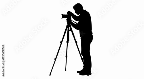 Silhouette of a photographer using a tripod to capture a shot.