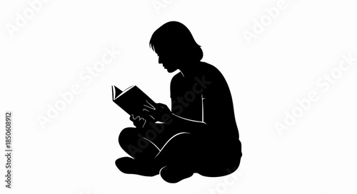 Silhouette of a person sitting cross legged reading a book.