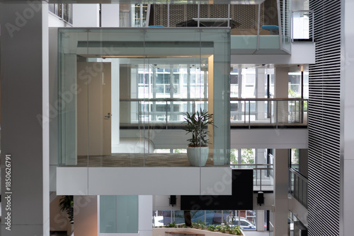 Photos Modern glass office atrium with empty meeting area