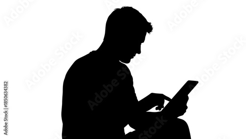 Silhouette of a person intently focused while interacting with a digital tablet device against a white background