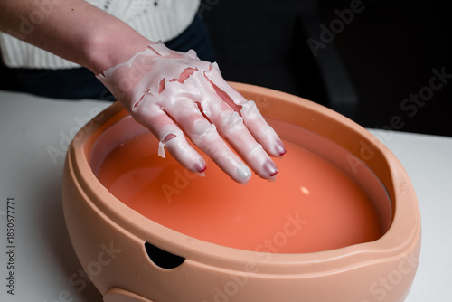 Fotografie Process paraffin treatment of female hands in beauty salon