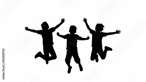 Silhouette of three happy children jumping in the air.