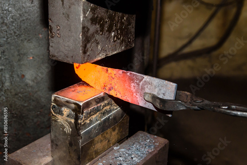A Blacksmith making knives in the old traditional smithy factory