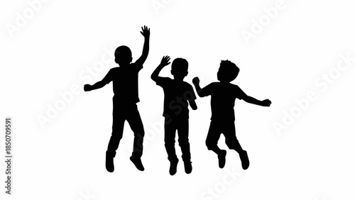 Silhouette of three happy children jumping and playing together.