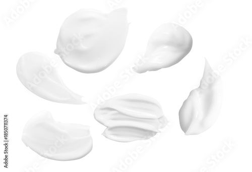 Fotografie a pristine, top-down photograph features multiple smooth, dollops of white cream arranged on a sleek, solid black surface for versatile applications