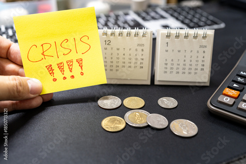Принти на полотні Hand holding sticky note with CRISIS text and 2026 calendar for economic warning concept