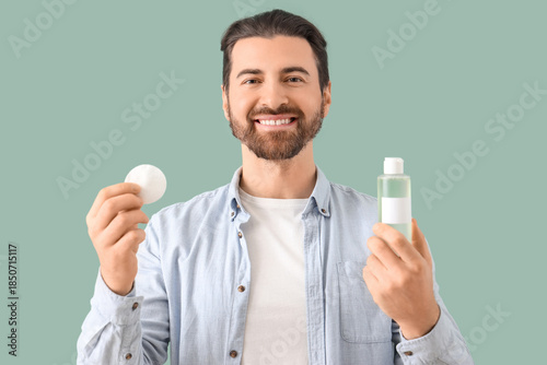 Handsome man with bottle of...