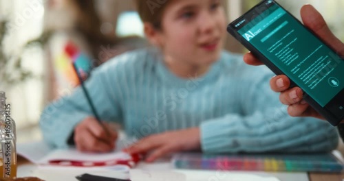 Father holds a smartphone using an AI chat app to help his daughter with homework. Modern learning, technology support, and family education at home.