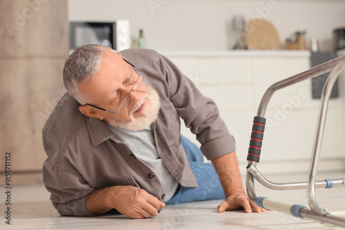Senior man lying on floor a...