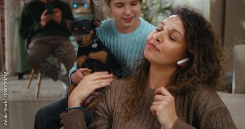 Stressed mother working online from home feels overwhelmed by work. Her daughter hugs her, bringing comfort and calm. Family support helps ease stress and restore emotional balance.