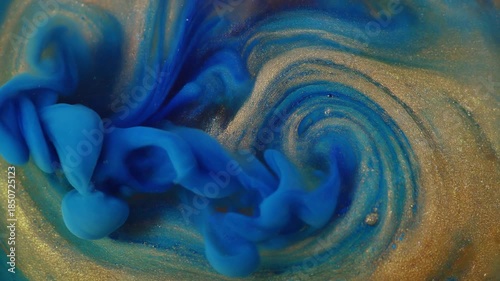 Abstract Blue Ink Swirls in Golden Liquid, Macro Fluid Dynamics