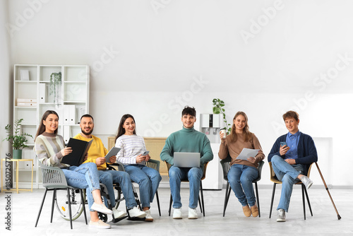 Photos Young man in wheelchair with applicants waiting for job interview at office