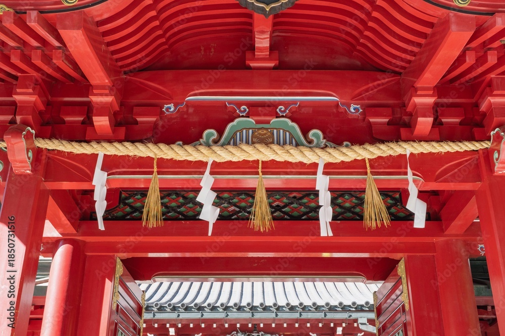 Fototapeta premium August 29, 2023. Hankone, Kanagawa, Japan. A rope tied across the entrance of Hakone Shrine called the shimenawa.