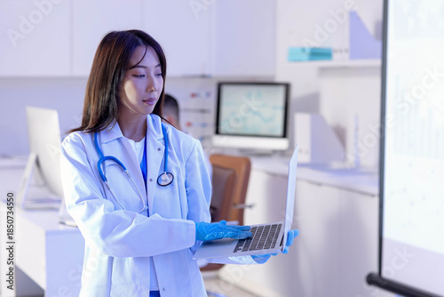Female Asian doctor with la...
