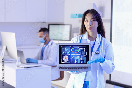 Female Asian doctor with la...