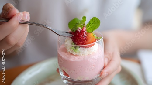 person eating a strawberry mousse