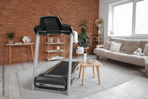 Treadmill near brick wall i...