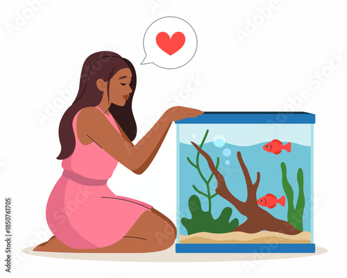 A thoughtful woman in a pink dress gazing lovingly at her fish tank, illustrating the comfort and joy that pets can bring to our lives and the connection we feel.