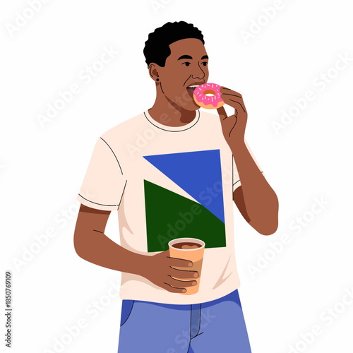 A young man takes a bite of a sweet donut while holding a cup of coffee, highlighting moments of indulgence and pleasure in everyday life.