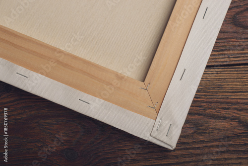 Stretched canvas on wooden stretcher frame lying on textured table