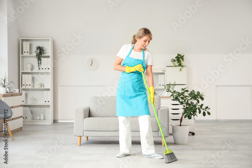 Female janitor sweeping flo...