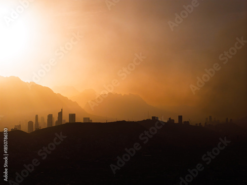 Aerial view of Valle Oriente skyline with Sierra Madre Mountains silhouette obscured by smoke from brush fires