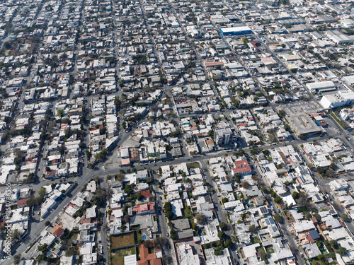 High angle aerial view of Monterrey city residential grid and buildings