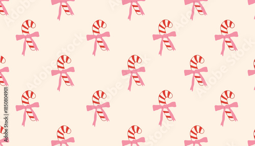 Festive Pattern of Candy Canes with Pink Ribbons on a Cream Background, Ideal for Holiday Decorations and Celebrations