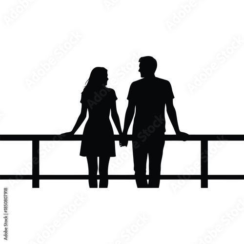 A romantic silhouette of a couple holding hands and leaning on a railing