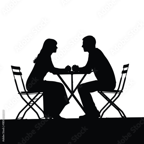 A couple in silhouette sits intimately at a table, sharing a quiet moment together.