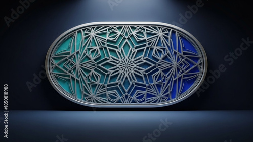 Intricate silver oval frame with geometric pattern on blue green background, illuminated from above on dark surface