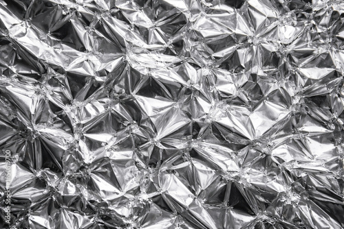Crumpled silver aluminium foil texture background