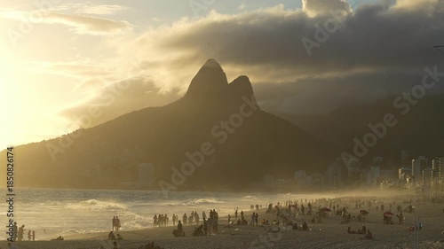 Rio de Janeiro, Brazil: Footage of people enjoying sunset in Ipenema beach, Rio de Janeiro, Brazil with dramatic sky above Two Brothers Mountain