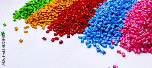 Colorful polymer plastic masterbatch pellets arranged by shade, showcasing high-quality additives used to enhance color, stability, and performance in plastic manufacturing processes efficiently