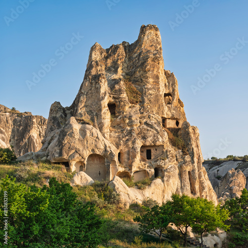 Cappadocia, Turkey: Ancient cave dwellings carved into unique fairy chimney rock formations in Goreme Valley
