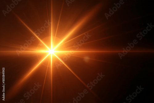 Golden Starburst Light Flare on Dark Background with Radiant Energy Beams