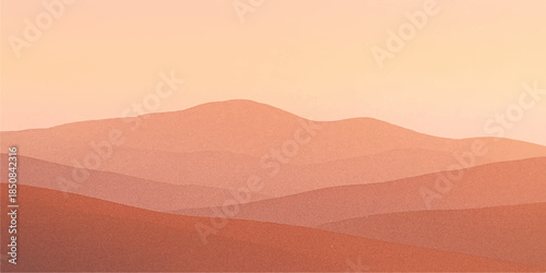 Golden sun sets behind majestic mountains over the arid Saharan wilderness where yellow sand dunes create a vast summer landscape of heat and adventure in the Moroccan desert