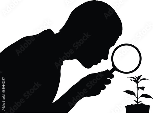 Silhouette of a person examining a plant with a magnifying glass