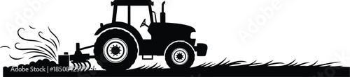 Silhouette of a tractor plowing soil in a field