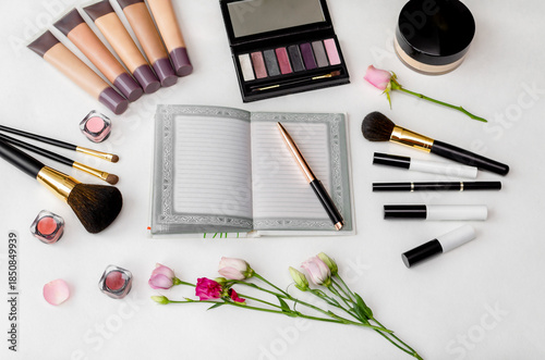 Cosmetics and accessories arranged on a white surface.