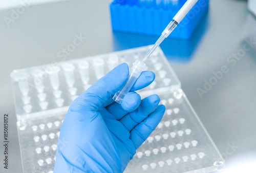 Doctor holding blood tube test in the research laboratory.Corona virus pandemic concept.Coronavirus vaccine development