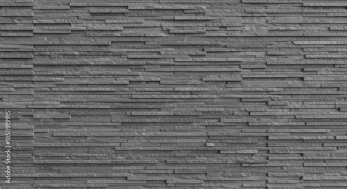 A seamless modern gray stacked stone wall surface background showing contemporary architectural design texture detail, abstract, background, wall