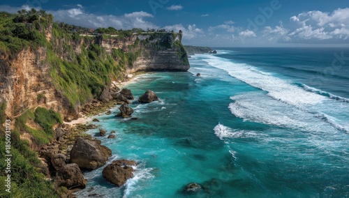 A stunning coastal scene with lush green cliffs, turquoise waters, and gentle waves