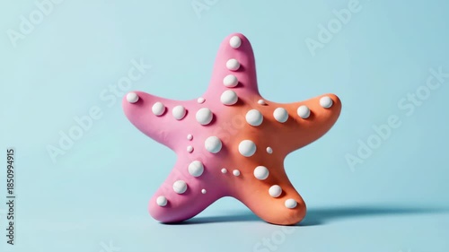 Vibrant Pink and Orange Starfish on a Light Blue Background.